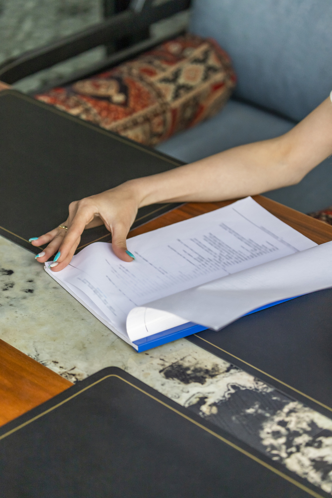 Woman reviewing family law litigation paper Woman reviewing family law litigation paper